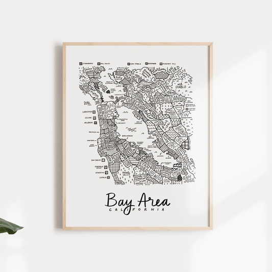 A framed black and white map print of the San Francisco Bay Area displayed against a white background with leafy decorative elements.