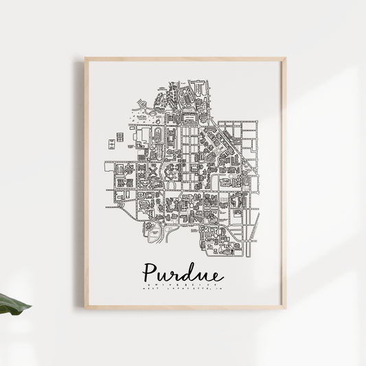 Black and white print of Purdue University campus map, framed and displayed against a white background with leaves in the foreground.