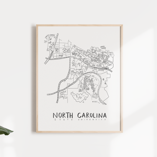 Black and white print of a hand-illustrated map of North Carolina State University, framed and displayed against a neutral background.