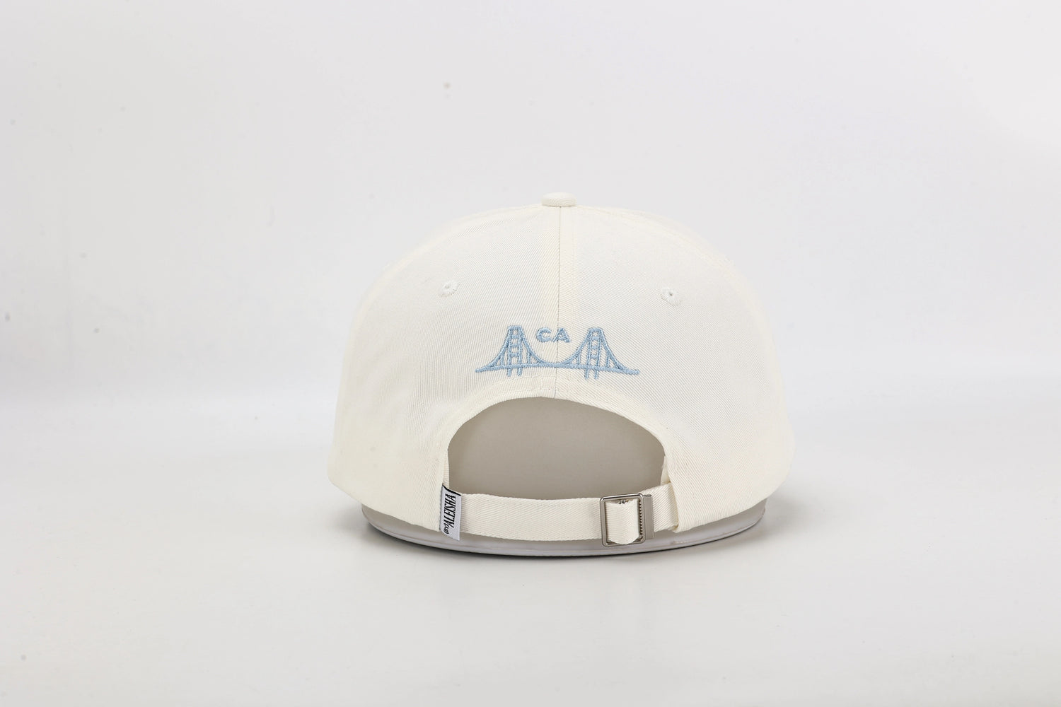 Embroidered San Francisco and city by the bay lettering on cream dad hat