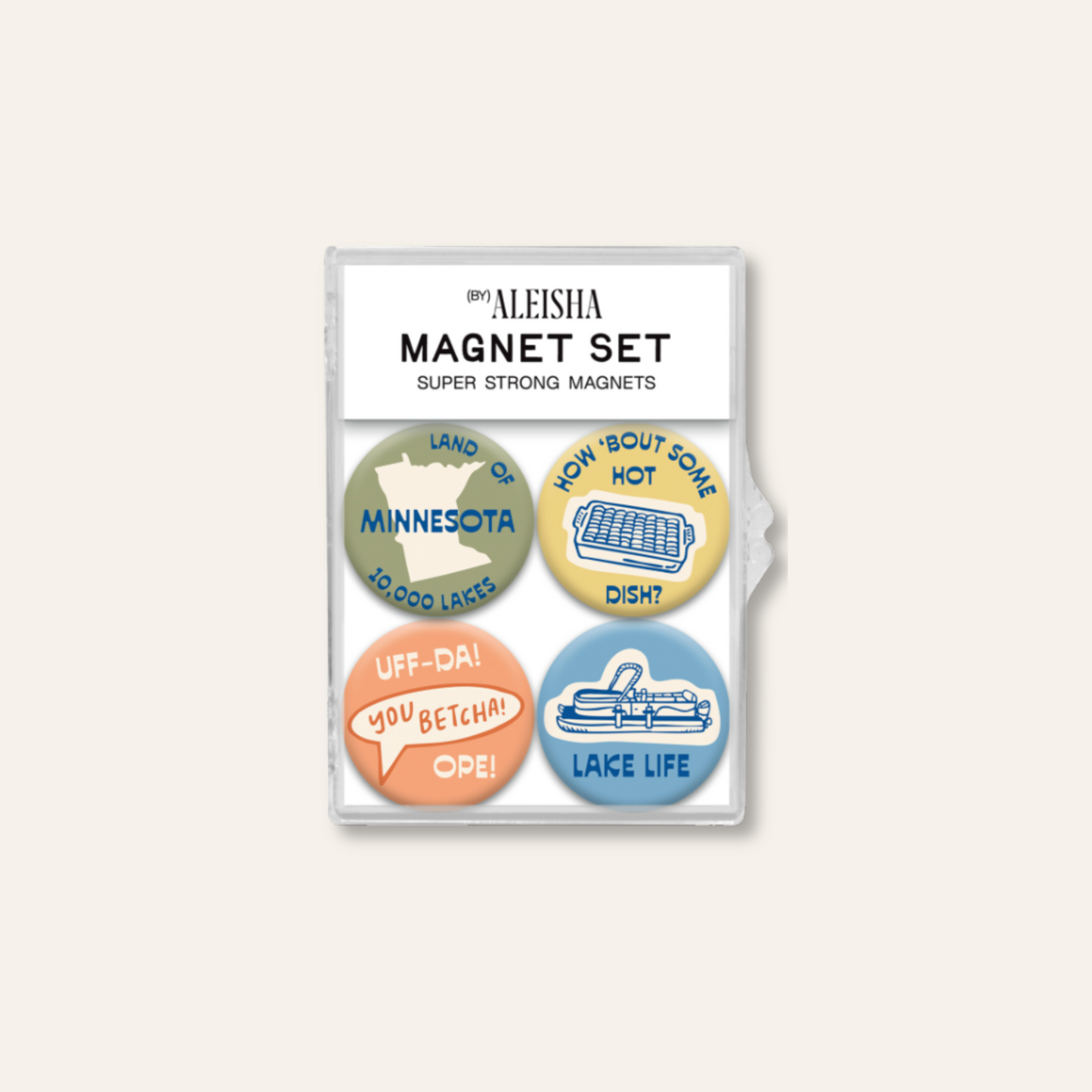 A package of four round magnet pins by Aleisha, featuring Minnesota-themed designs including 'Uff-DA! You Betcha! OPE!', and 'Lake Life' in muted green, yellow, orange, and blue colors.