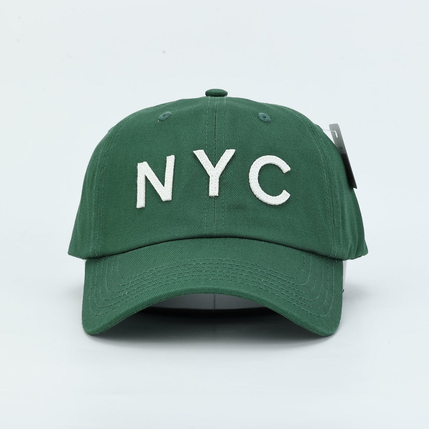 Forest Green Dad Hat with ivory felt cutout letters spelling "NYC"